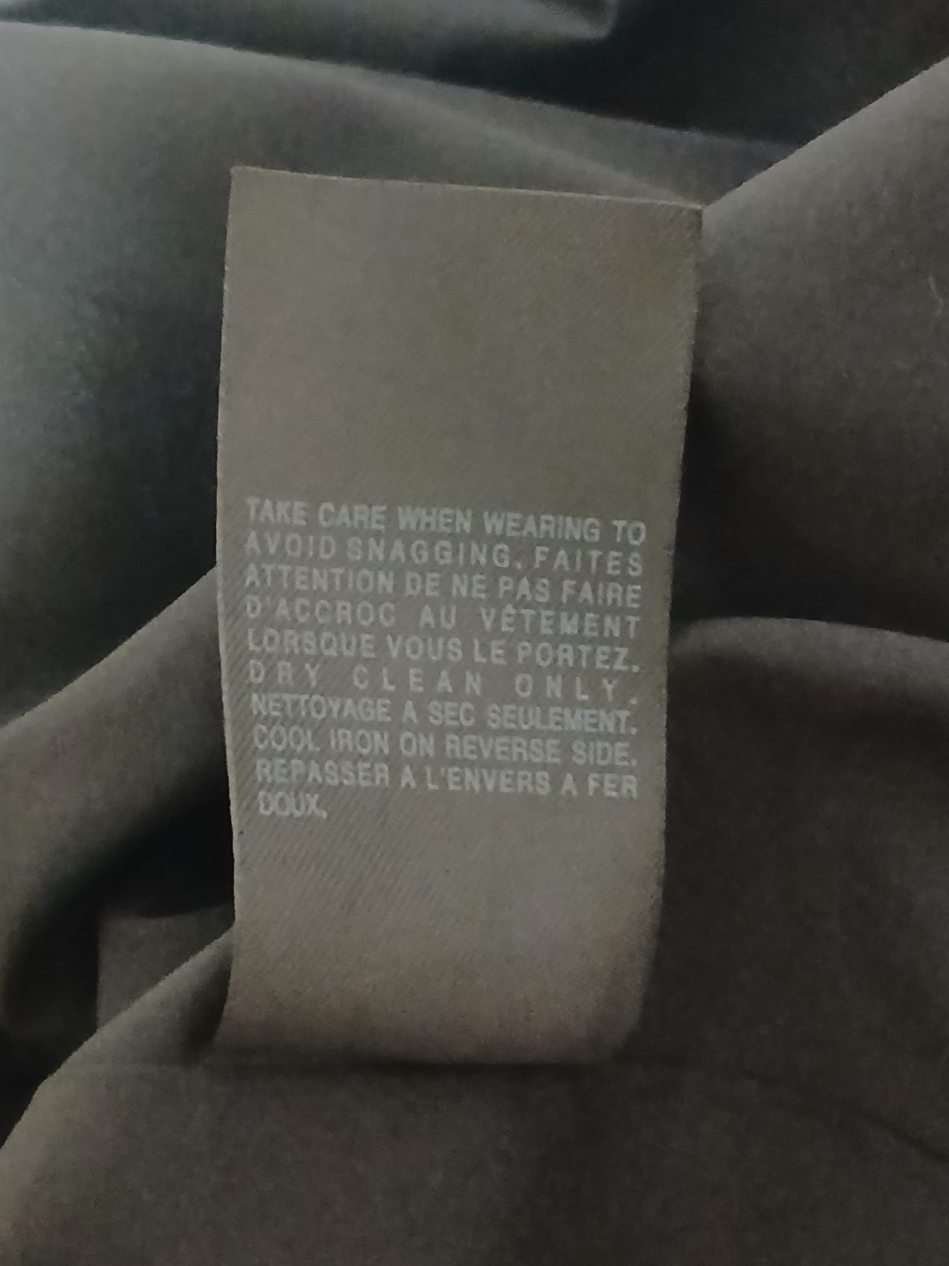 Department Store UK AllSaints Spitalfields dress care label with dry clean only instructions in English and French