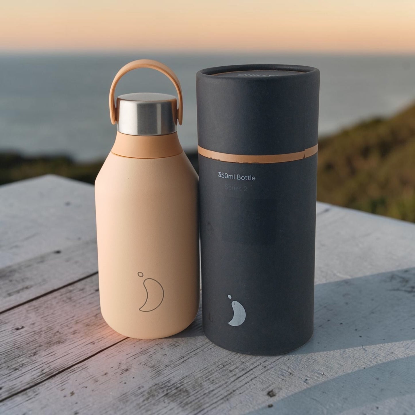 Department Store UK Chilly's Series 2 peach orange insulated stainless steel bottle with carry loop and gift tube.