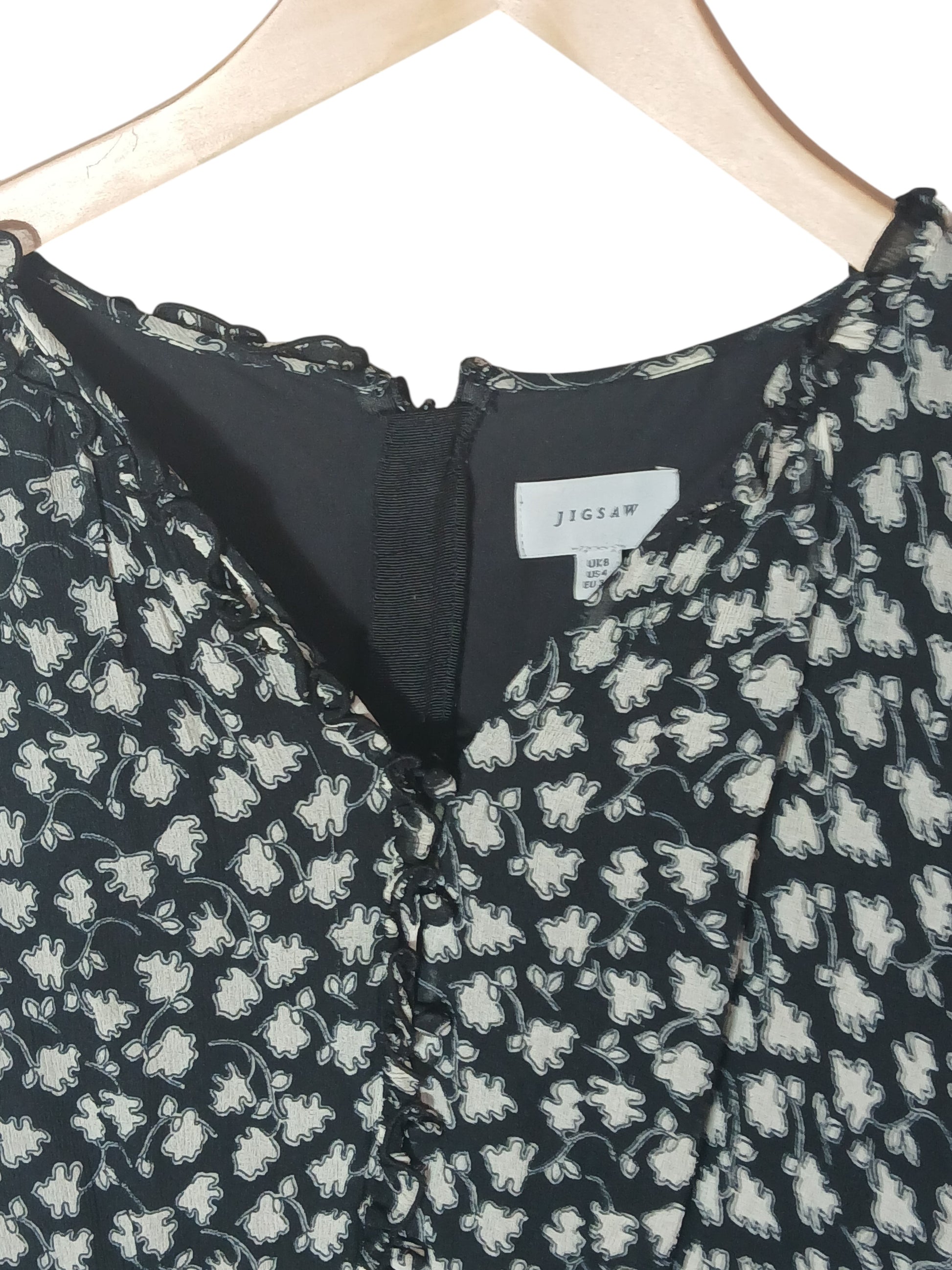 Department Store UK Jigsaw dress in black and white floral print with a ruffled neckline and back zip closure