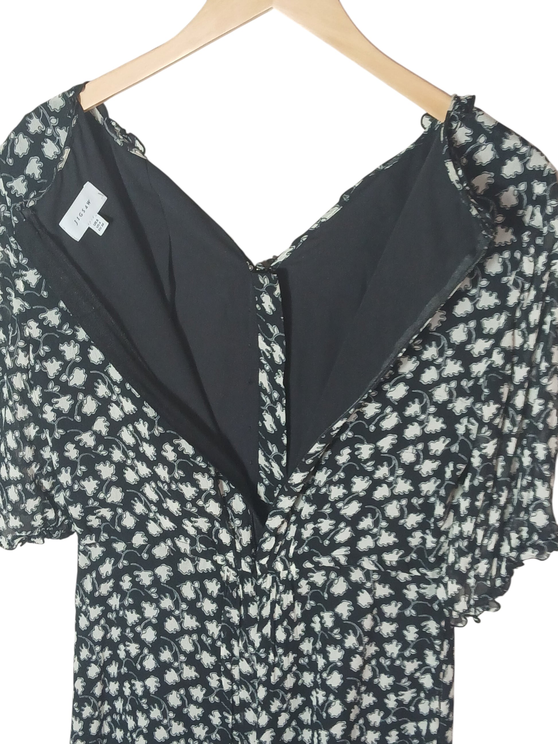 Department Store UK Jigsaw floral print dress with V-neck and back zipper closure on a wooden hanger