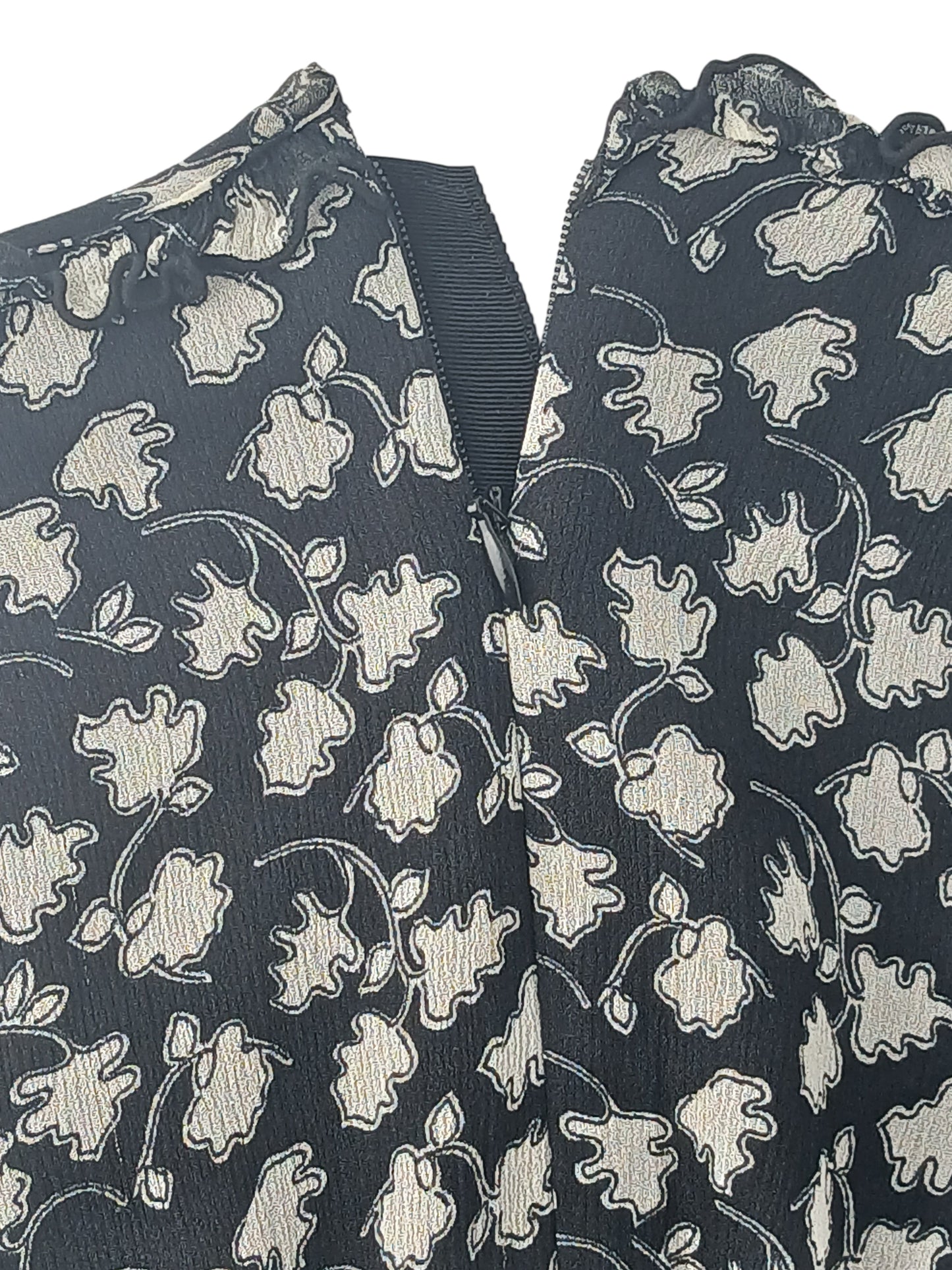Department Store UK Jigsaw dress featuring a black and cream floral print with a ruffled neckline and back zipper