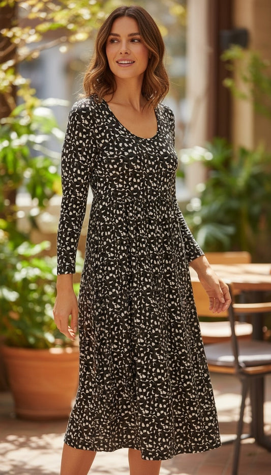 Department Store UK midi dress in monochrome animal print with scoop neck and long sleeves on a smiling woman