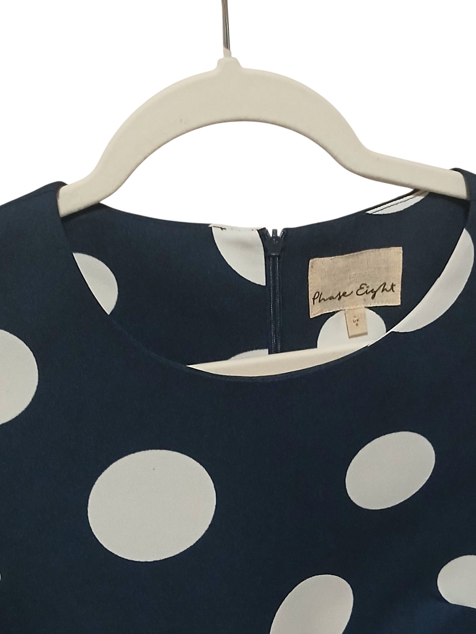 Department Store UK Phase Eight navy blue shift dress with large white polka dots and round neckline on a hanger