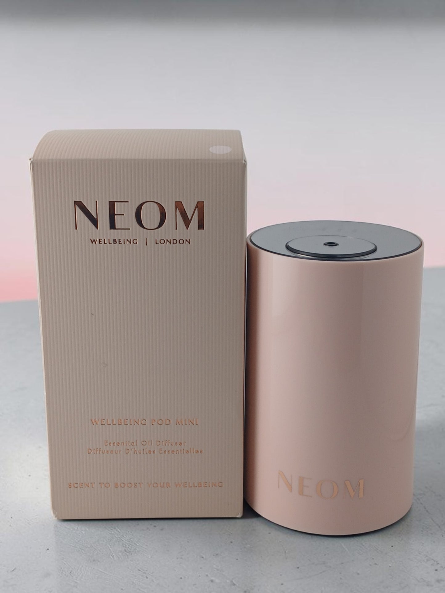 Department Store UK NEOM Wellbeing Pod Mini essential oil diffuser in blush pink with its matching product box.