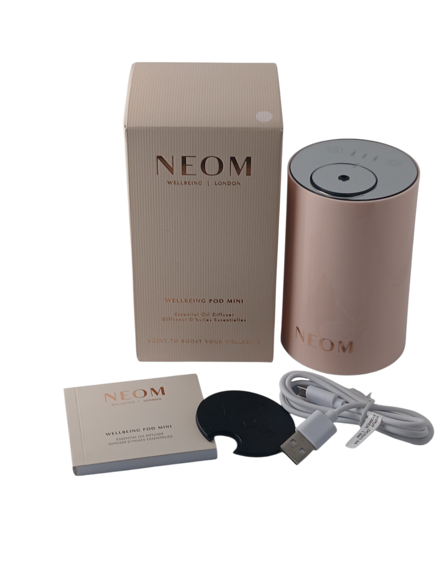 Department Store UK NEOM Wellbeing Pod Mini essential oil diffuser in blush pink with packaging, manual, and USB cable.