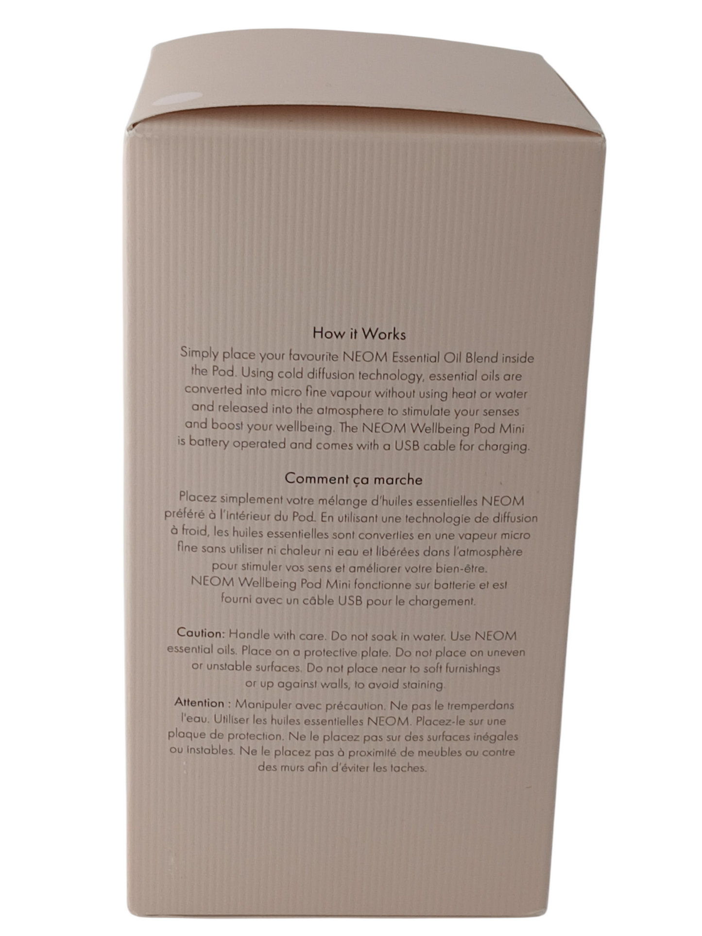 Department Store UK NEOM Wellbeing Pod Mini packaging box with instructions in English and French on a blush surface