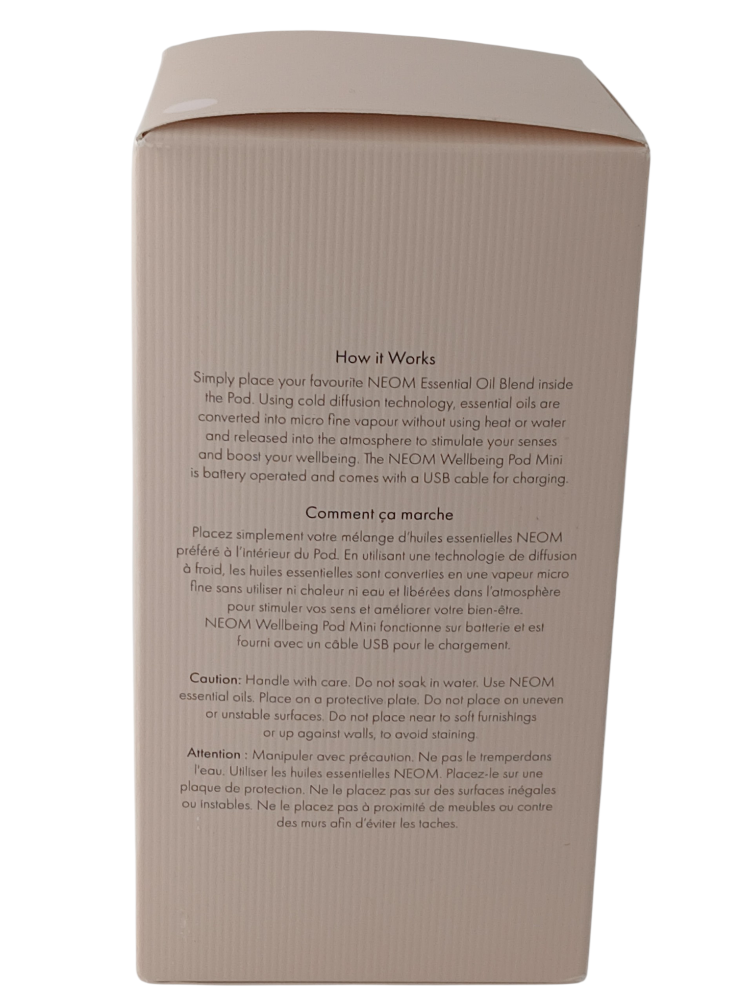 Department Store UK NEOM Wellbeing Pod Mini packaging box with instructions in English and French on a blush surface