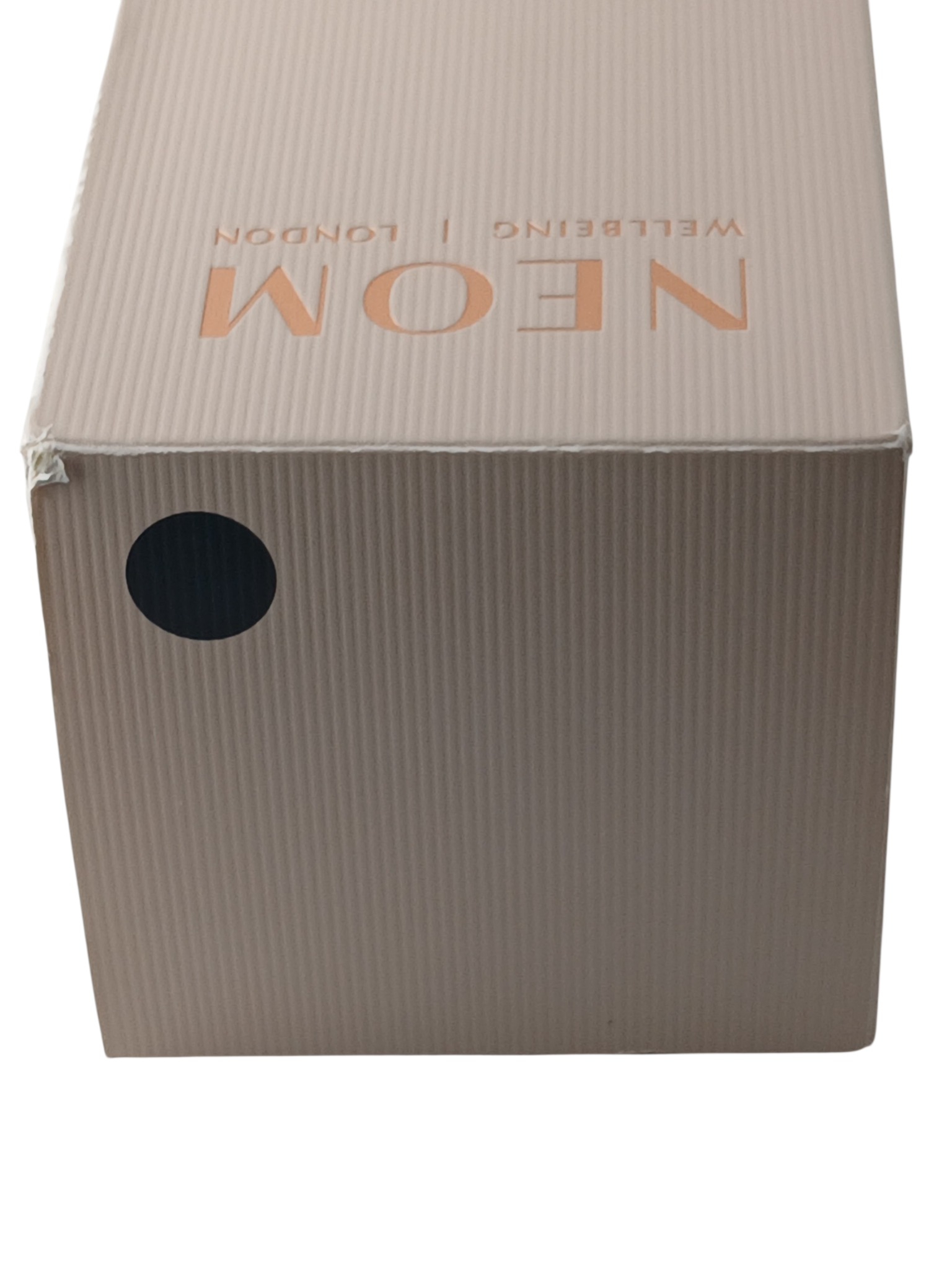 Department Store UK NEOM Wellbeing Pod Mini+ branded cardboard packaging box with a matte black circular label
