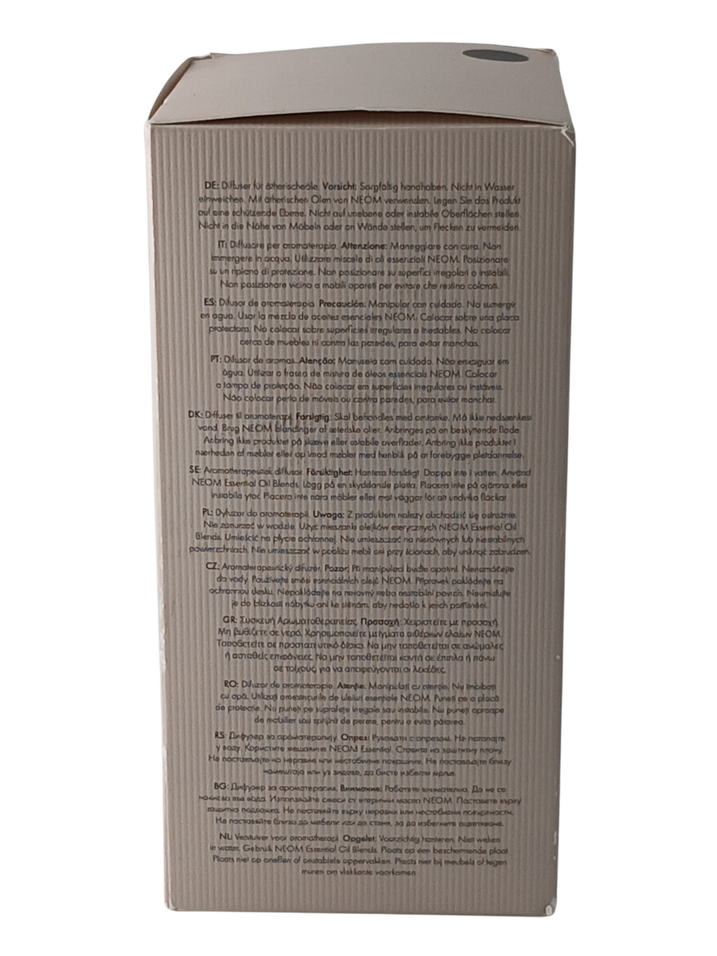 Department Store UK packaging for NEOM Wellbeing Pod Mini+ featuring multilingual safety instructions on the back