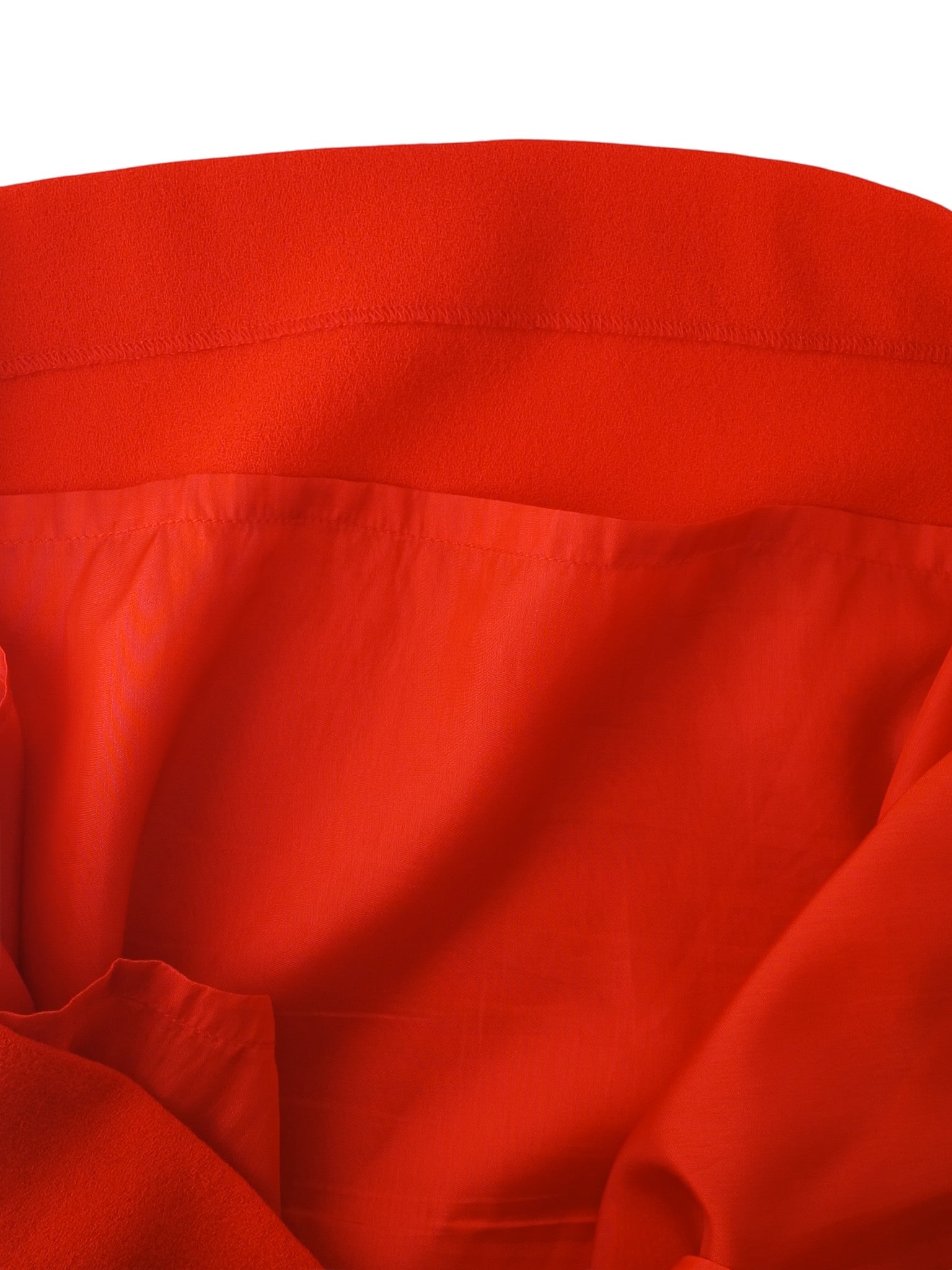 Close-up of the vibrant red fabric lining and hem of a P.A.R.O.S.H. shift dress from Department Store UK.