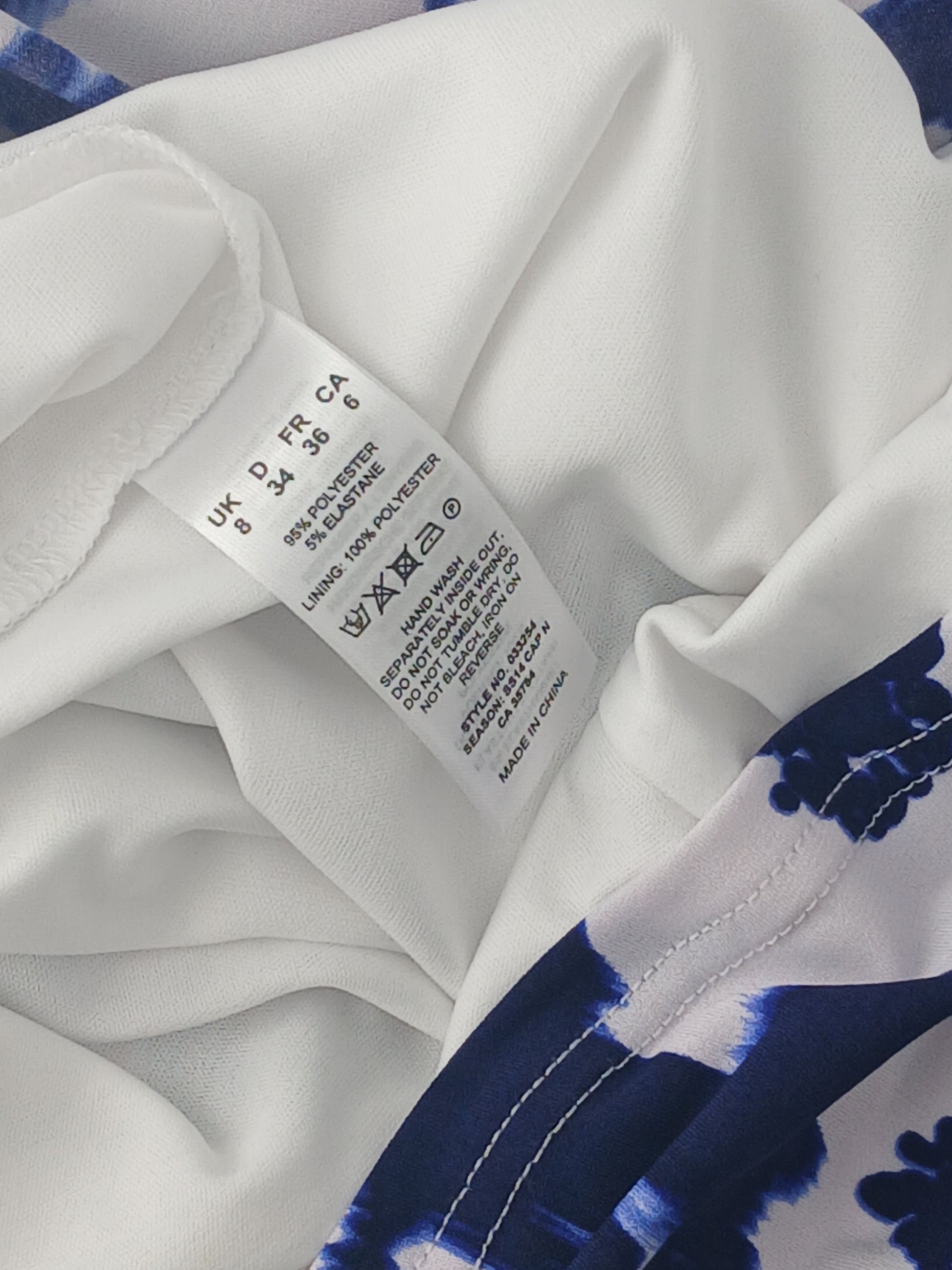 Department Store UK pre-loved Precis Petite dress care label showing polyester and elastane fabric composition