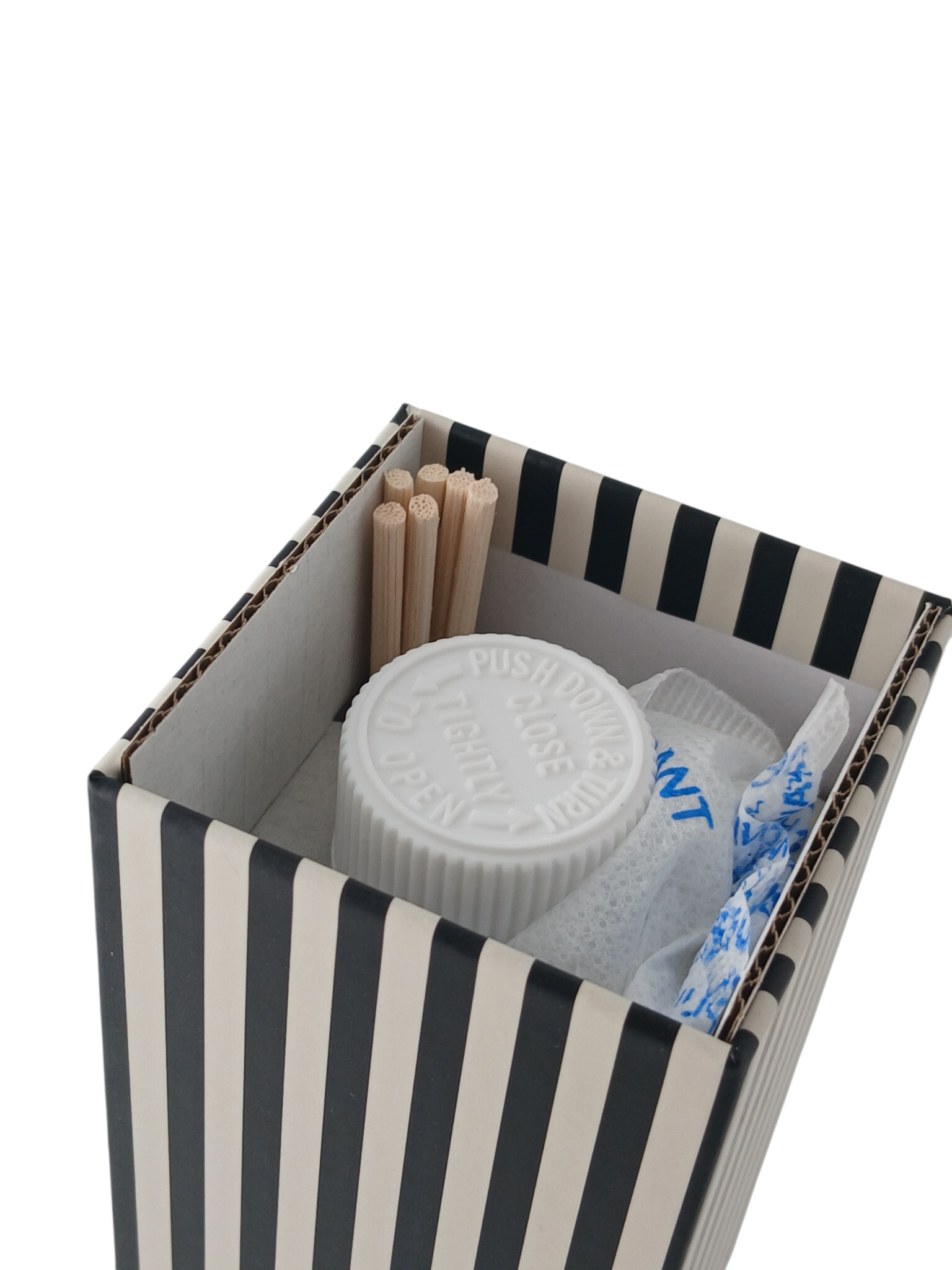 Department Store UK Paddywax reed diffuser set inside a black and white striped box with wooden reeds and white cap