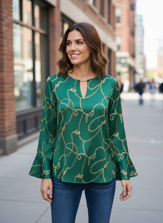 Department Store UK Sosandar green and gold rope print blouse with bell sleeves worn by a woman on a city street