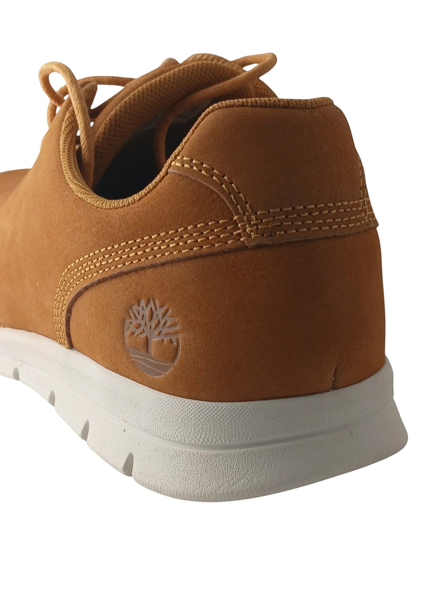 Department Store UK Timberland tan suede lace-up sneakers featuring an embossed tree logo on the heel and white sole.