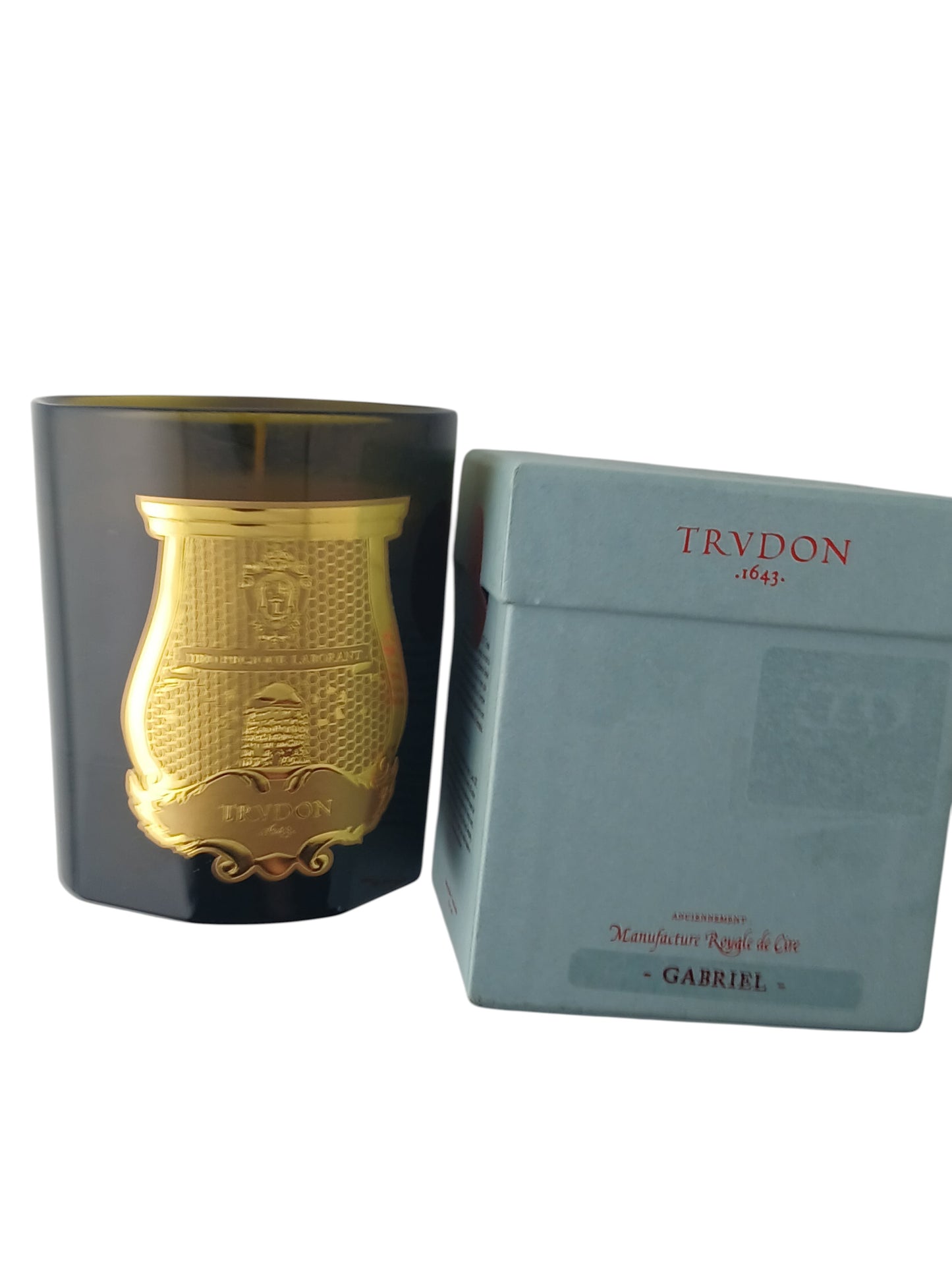 Department Store UK Trudon Gabriel scented candle in a dark glass vessel with a gold emblem next to its gift box.